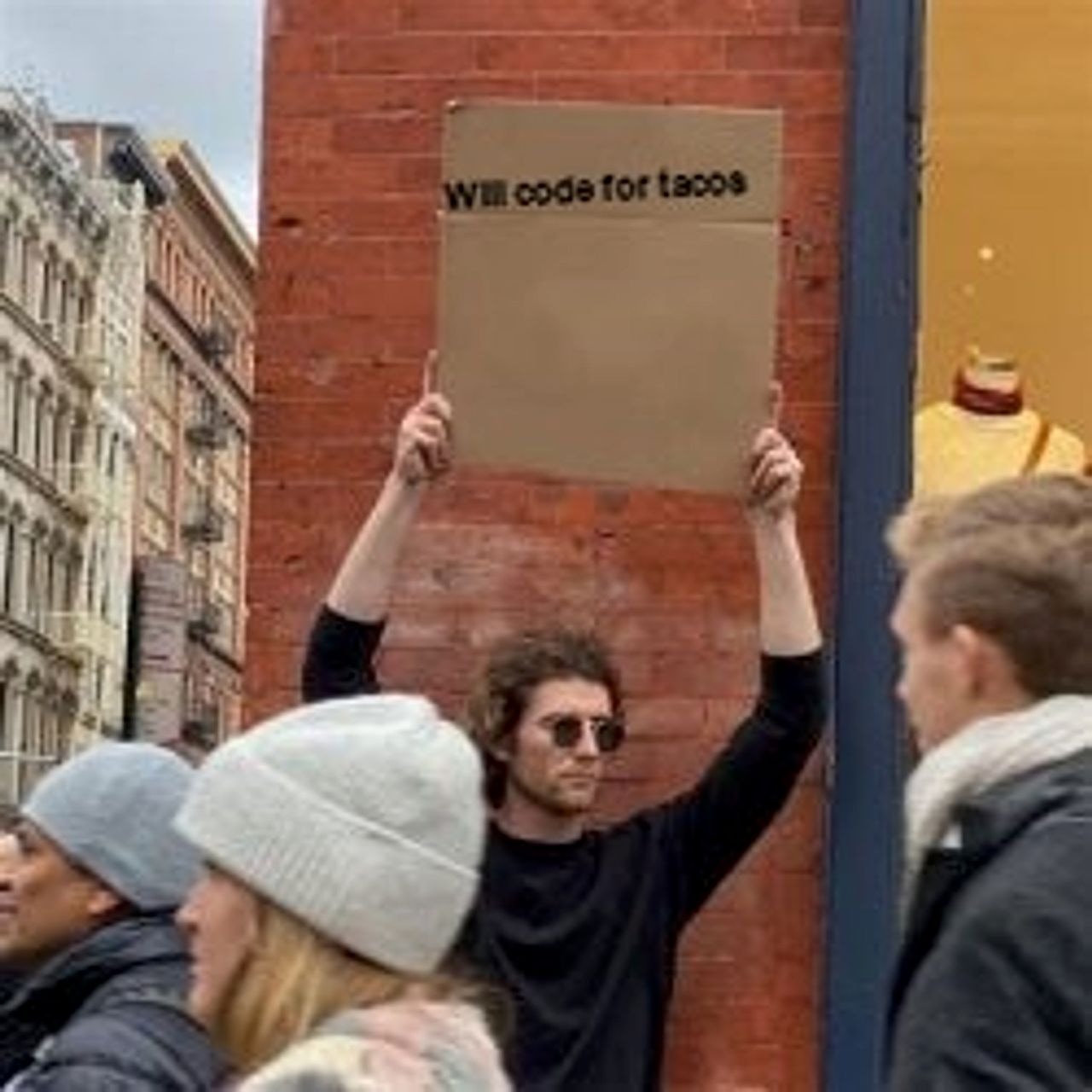 Man Holding Cardboard Sign seeded example