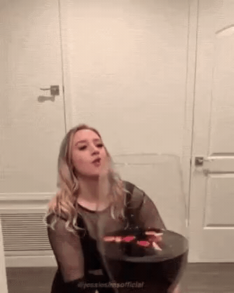 Add text to the Woman Drinking Wine reaction GIF template in Memesio. Set width, trim the clip, and make a share-ready GIF meme.